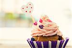 Photo of cute cupcake with heart shape stick