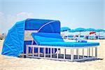 Luxurious beach bed with canopy on a sandy beach