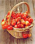 Sweet Maraschino Cherries in Wicker Basket on Wooden background. Retro Styled