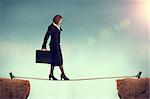 businesswoman balancing on a tightrope conquering adversity concept