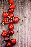 Red Ripe Sweet Cherries In a Row on Rustic Wooden background