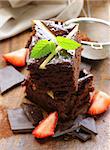 homemade chocolate cake (brownie) on a wooden board