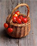 Sweet Maraschino Cherries in Wicker Basket isolated on Rustic Wooden background