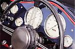 dashboard dials and steering wheel of a vintage sports car