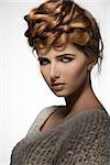 young pretty girl posing with creative elegant hair-style and natural make-up, perfect skin, sensual eyes