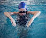 Fit woman swimming in the pool at the leisure center