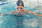 Fit swimmer coming up for air in the swimming pool at the leisure center