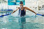 Fit swimmer doing the butterfly stroke in the swimming pool at the leisure center