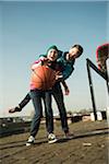 Teenage boy and girl playing basketball outdoors, industrial area, Mannheilm, Germany