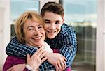 Portrait of teenage grandson with grandmother at home, Germany