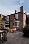 Garden furniture on patio of brick terraced house, Macclesfield, Cheshire, England, UK