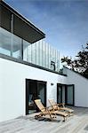 Exterior looking along the deck and to the balcony and the exterior staircase, Tresithney, Cornwall, UK. Architects: Architects: Stan Bolt Architect