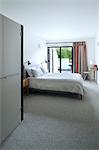 Master bedroom, lower ground floor in Tresithney, Cornwall, UK. Architects: Architects: Stan Bolt Architect