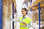 Female warehouse worker with digital tablet