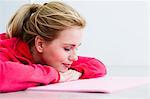 Young woman lying on exercise mat