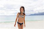 Girl standing on beach in Seychelles