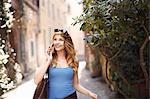 Young woman strolling on quaint street, Rome, Italy