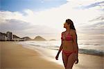 Mature woman strolling on Copacabana beach, Rio De Janeiro, Brazil