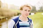 Portrait of teenage boy by rural river