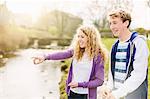 Teenage brother and sister on rural riverbank