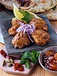 Chicken tikka with red onion slices and spices