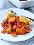 A plate of roast vegetable stew with cobblers