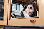 Portrait of young woman, looking through window of cable car