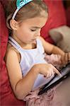 Close up of young girl using touchscreen on digital tablet