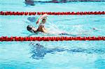 Swimmer racing in pool