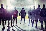 Silhouette of soccer teams facing field