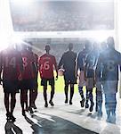 Silhouette of soccer players walking to field