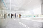 Business people walking in modern courtyard