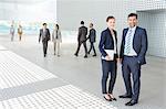 Portrait of business people outside modern building