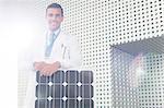 Portrait of scientist with solar panel in laboratory