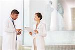 Doctors with digital tablet and clipboard in hospital