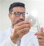 Scientist using caliper