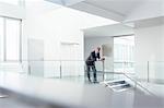 Businessman using digital tablet in corridor