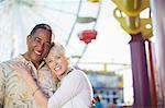 Portrait of smiling senior couple at amusement park