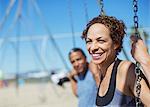 Happy couple on swings at playground