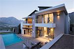 Modern house with swimming pool at dusk