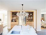 Chandelier hanging over luxury kitchen island