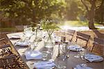 Bouquet and place settings on tranquil patio table