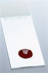 (Synthetic) Blood drop on a microscope slide