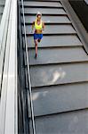 Jogger running down steps