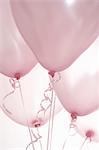 Still life of five pink balloons on ribbons