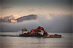 Excavator on barge,  Lake Maggiore, Varese, Piemonte, Italy