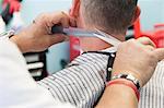 Barber cutting man's hair