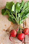 Three beetroot on a wooden surface