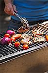 Chicken wings and vegetables on the barbecue