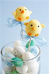 Easter chick cake pops and chocolate eggs in a glass